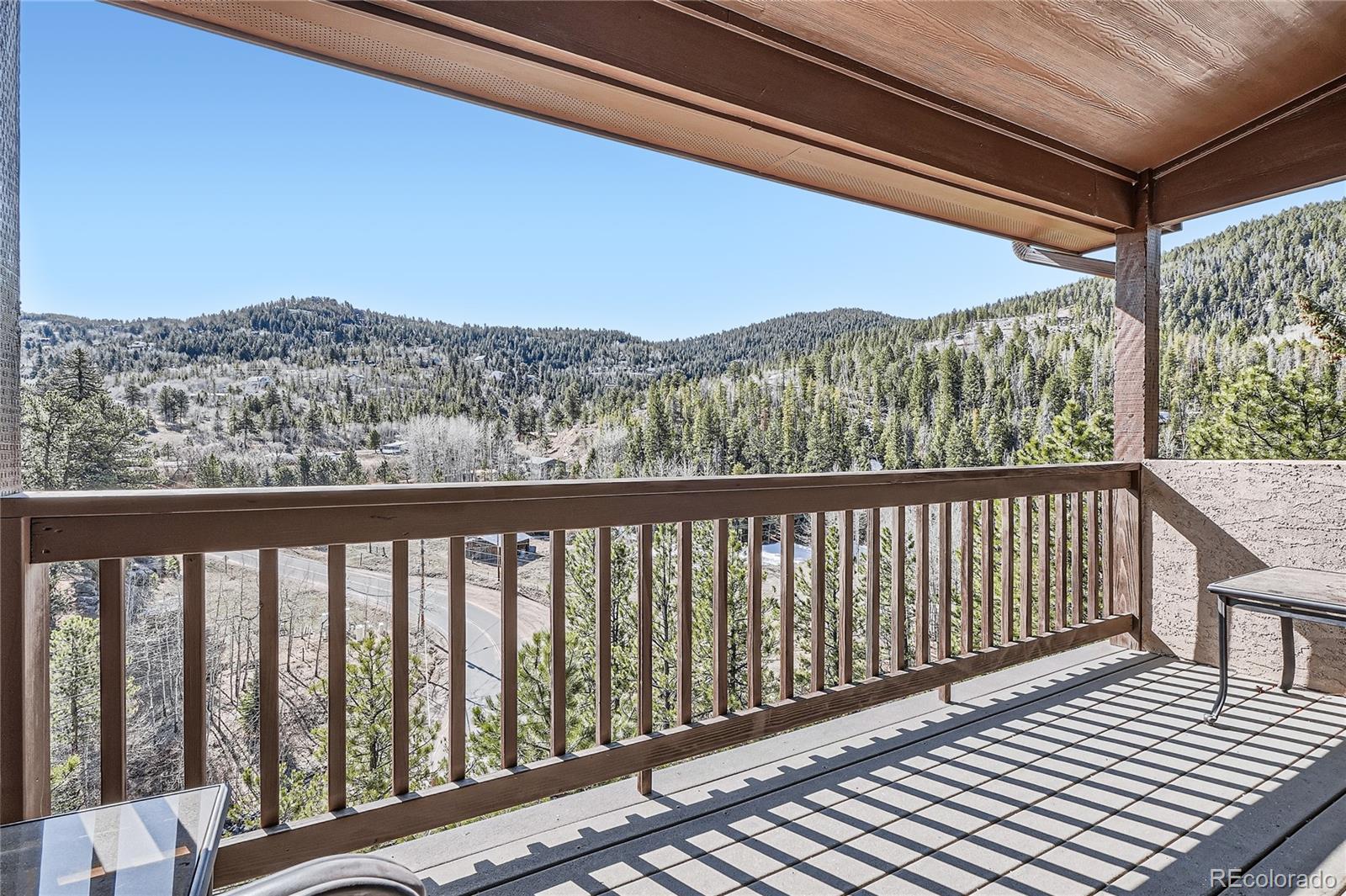 9659 South Turkey Creek Road Morrison, CO 80465 - Photo 26 of 48 a balcony with wooden floor and city view
