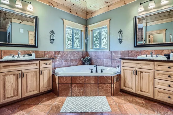 a spacious bathroom with a double vanity sink mirror and