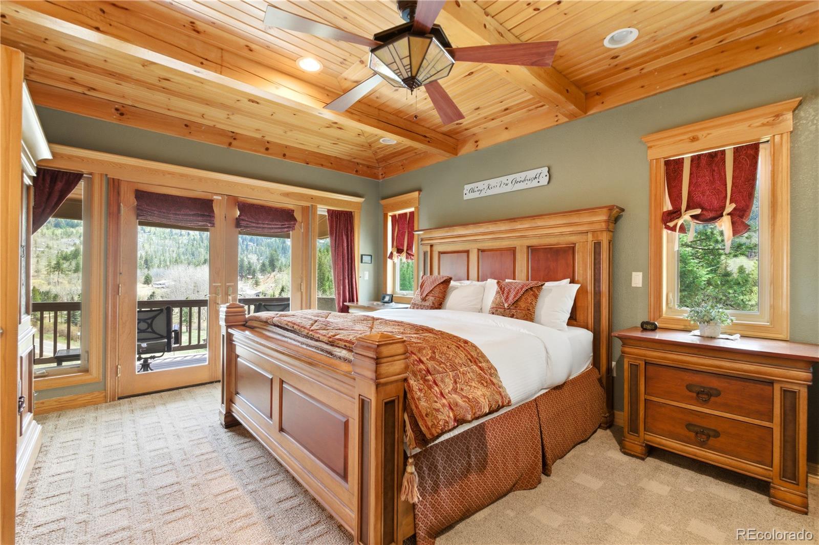 9659 South Turkey Creek Road Morrison, CO 80465 - Photo 28 of 49 a bed sitting in a bedroom next to a window