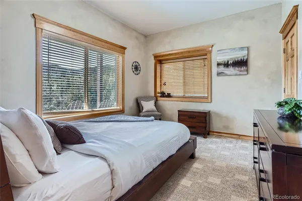 a bedroom with a bed and glass window