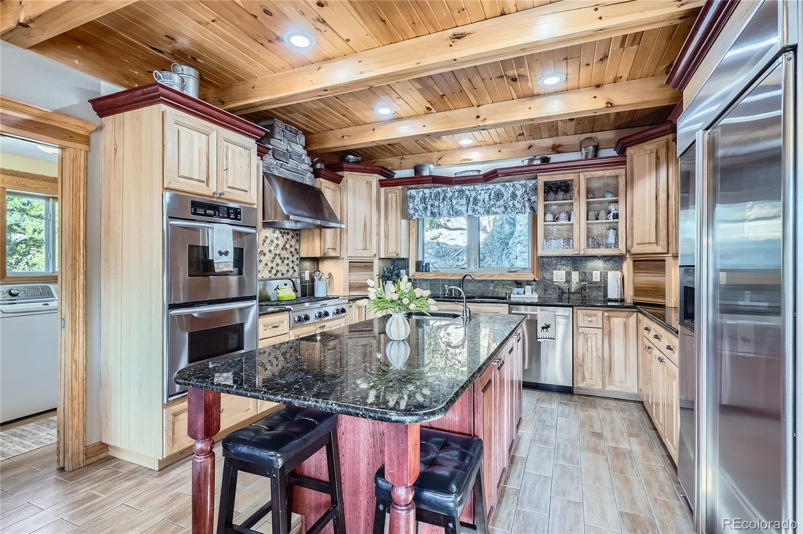 9659 South Turkey Creek Road Morrison, CO 80465 - Photo 3 of 48 a kitchen with stainless steel appliances granite countertop a sink a stove and a refrigerator