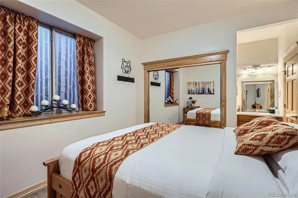 a bedroom with a bed and a painting on the wall