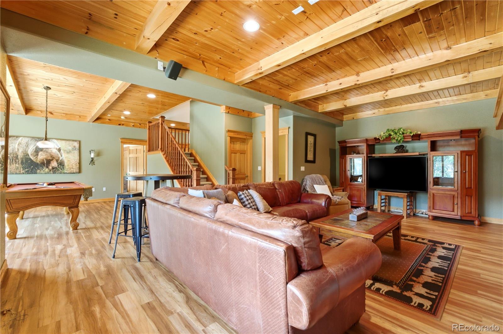 9659 South Turkey Creek Road Morrison, CO 80465 - Photo 35 of 49 a living room with furniture and a flat screen tv