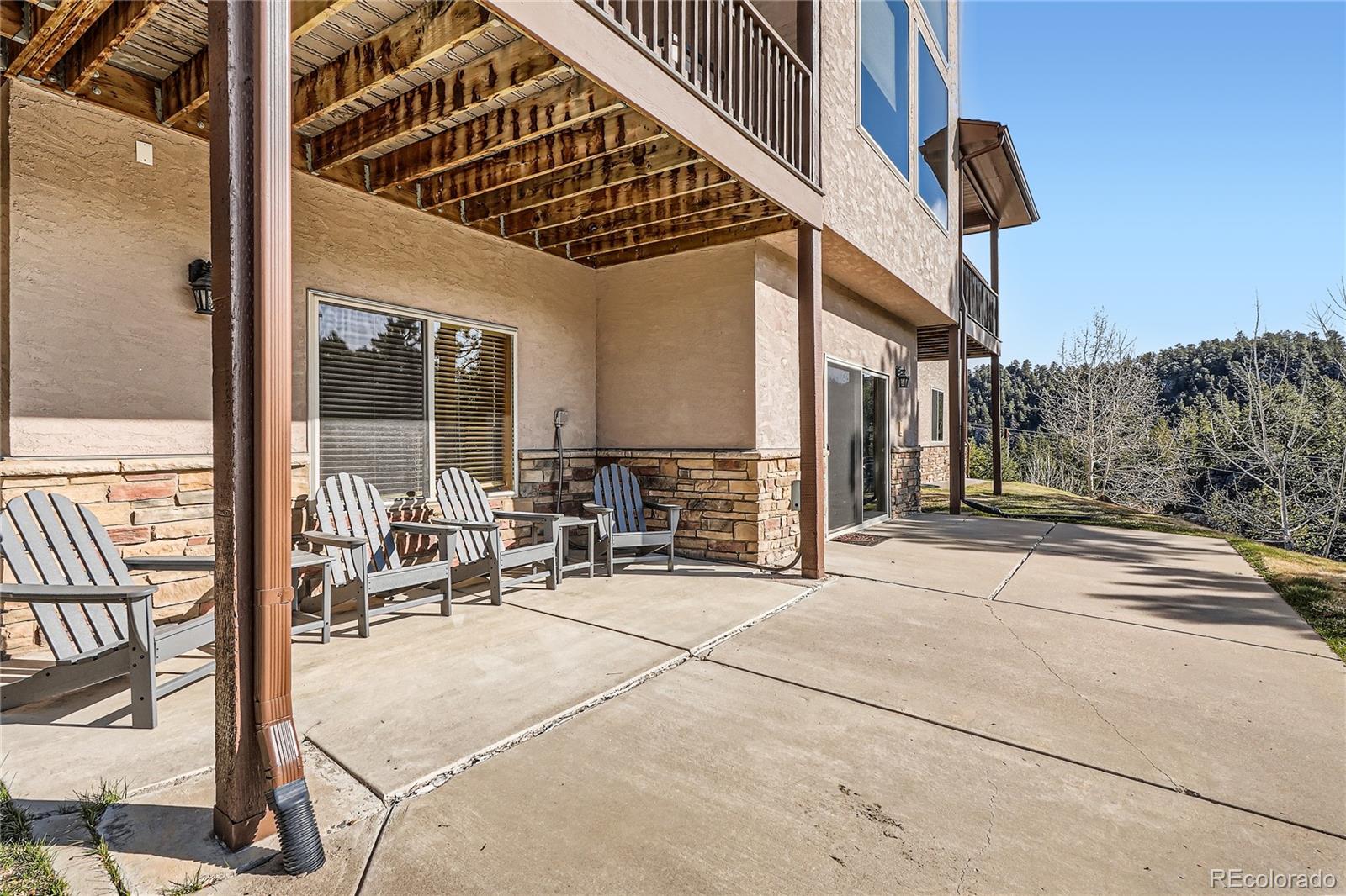 9659 South Turkey Creek Road Morrison, CO 80465 - Photo 35 of 48 a building outdoor space with patio furniture and potted plants