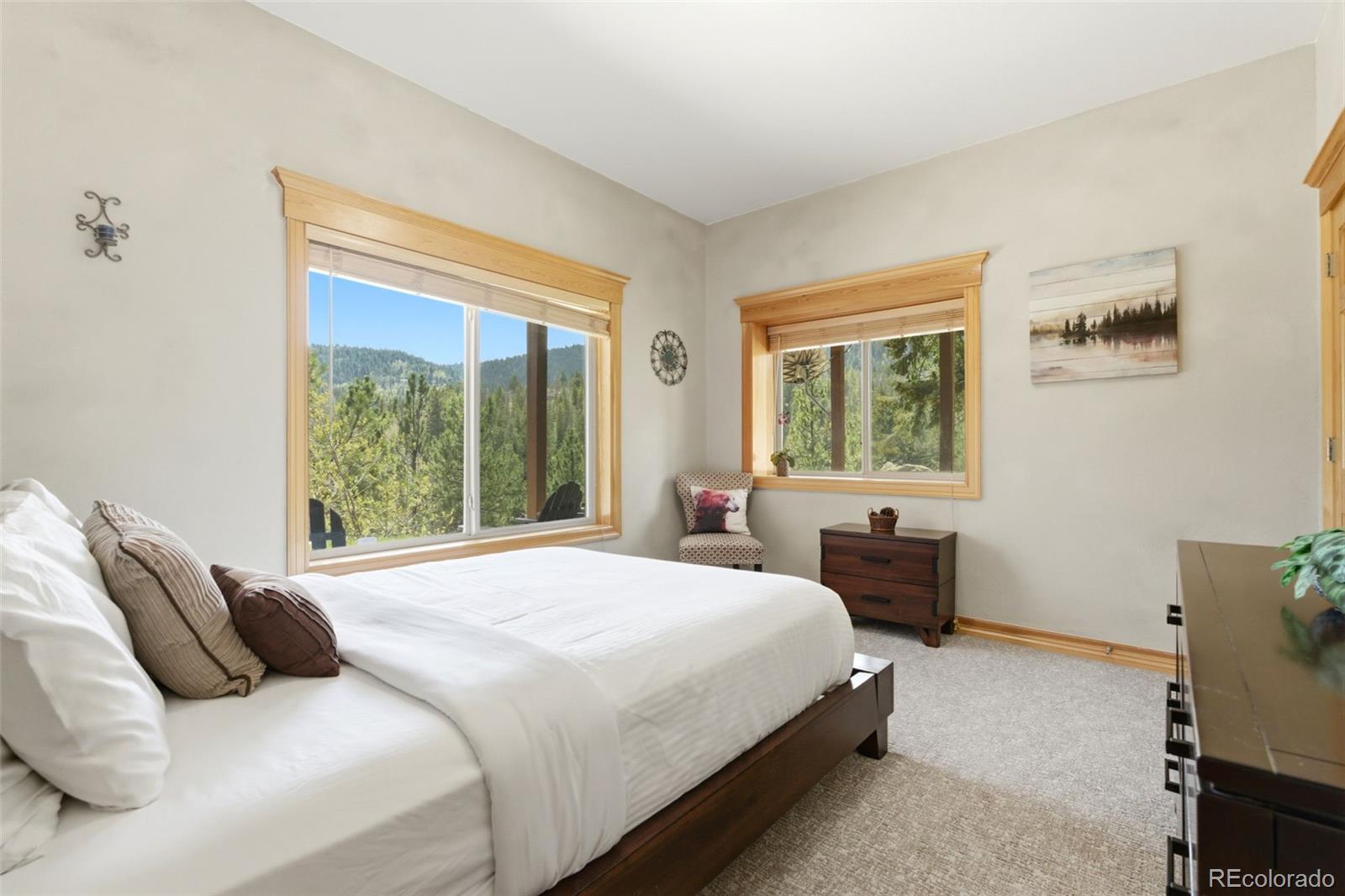 9659 South Turkey Creek Road Morrison, CO 80465 - Photo 38 of 49 a bedroom with a bed and a window