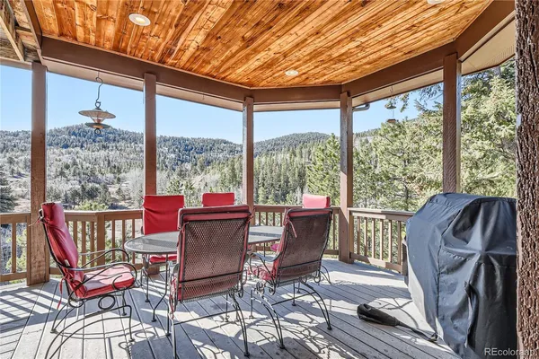 a view of a patio with a dining table and chairs