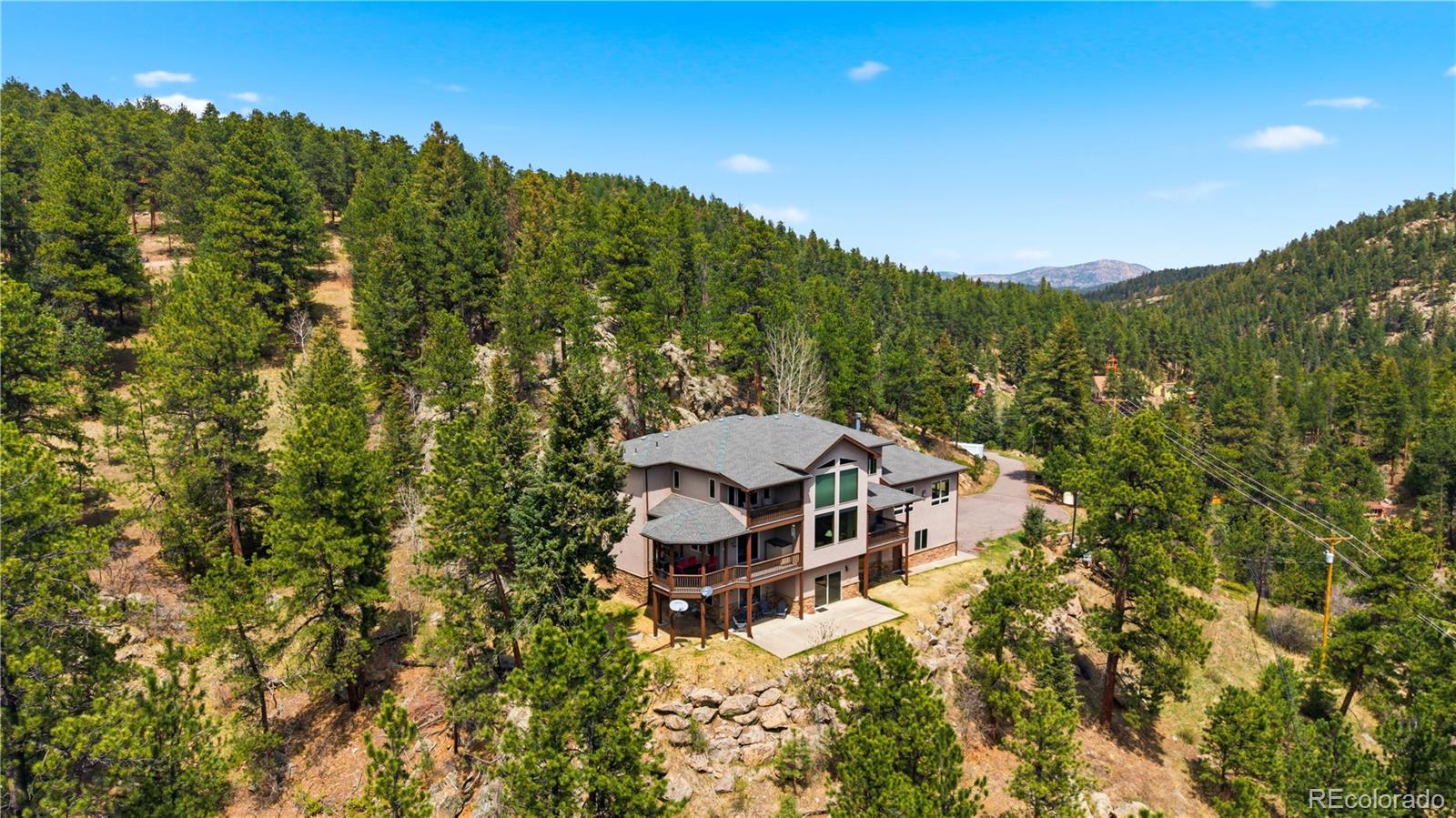 9659 South Turkey Creek Road Morrison, CO 80465 - Photo 42 of 49 view of a house with a mountain in the background
