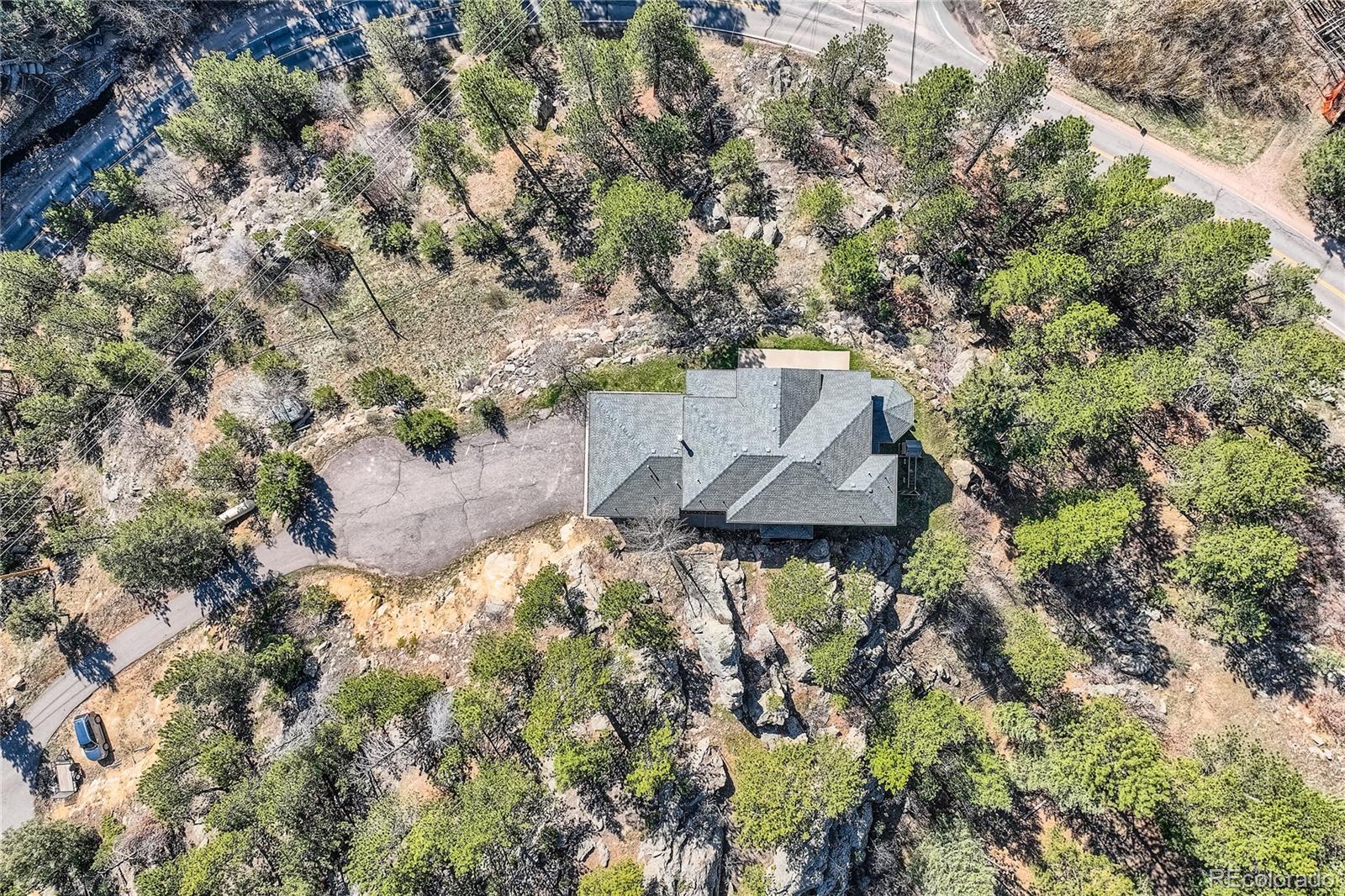 9659 South Turkey Creek Road Morrison, CO 80465 - Photo 42 of 48 an aerial view of a house with a yard and large tree