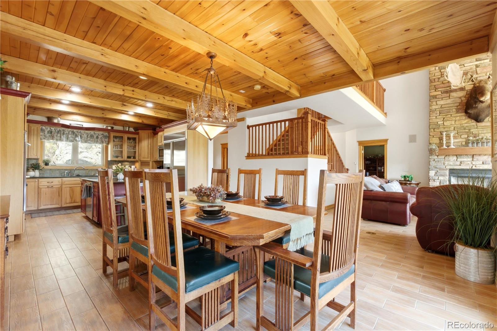 9659 South Turkey Creek Road Morrison, CO 80465 - Photo 7 of 49 a view of a dining room with furniture window and wooden floor