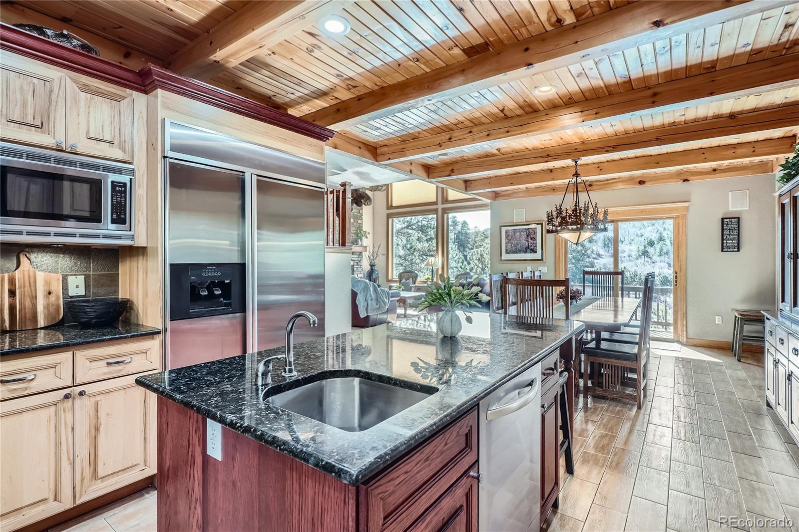 9659 South Turkey Creek Road Morrison, CO 80465 - Photo 10 of 48 a kitchen with stainless steel appliances granite countertop a sink and a counter space