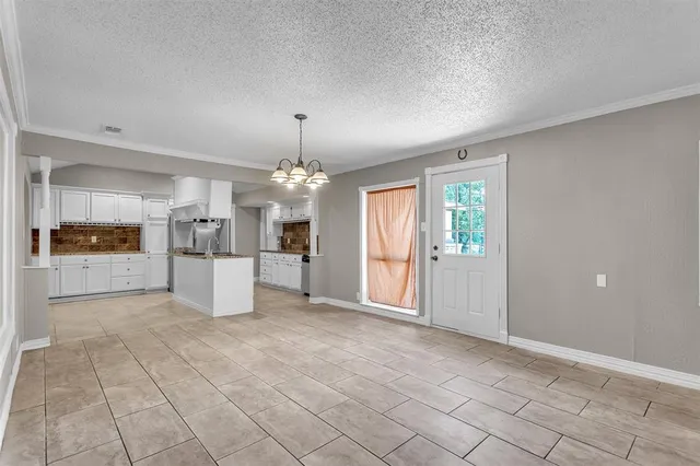 a view of a kitchen with granite countertop cabinets and refrigerator