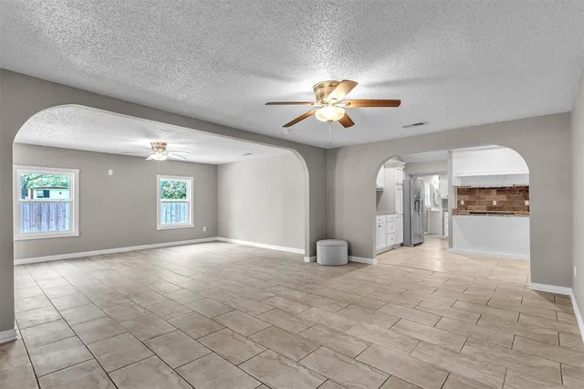a kitchen with stainless steel appliances kitchen island granite countertop a sink and cabinets