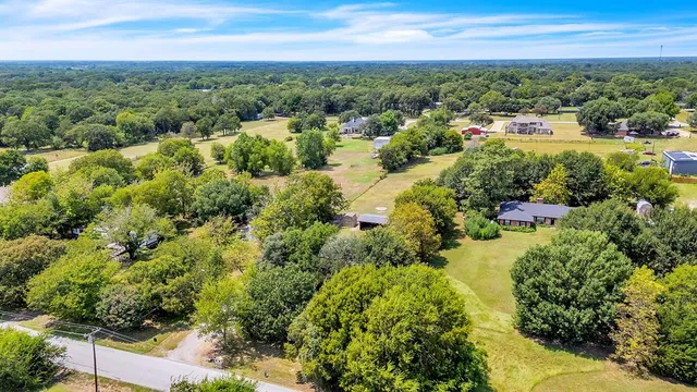a view of empty room with a chandelier fan and windows