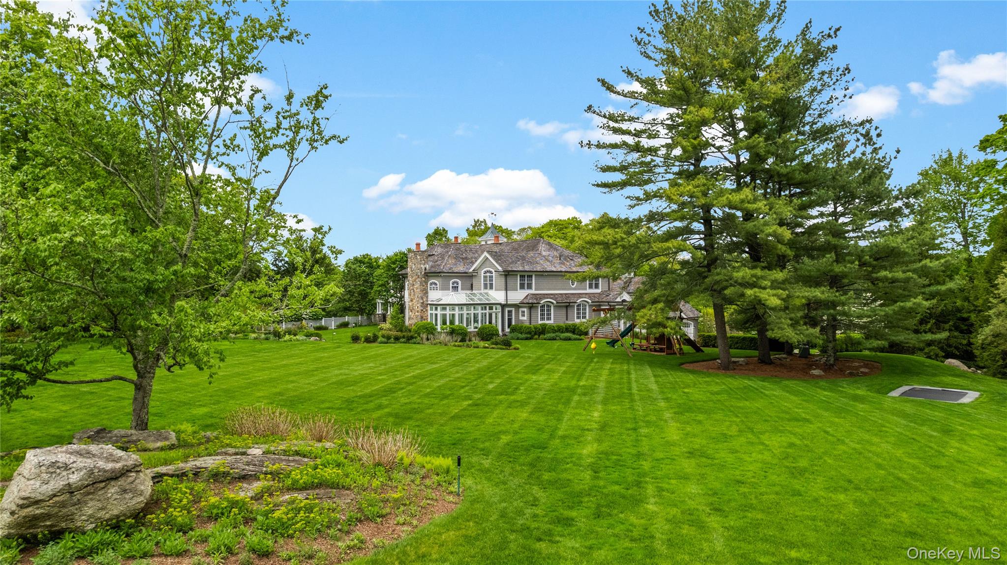 63 Old Mill River Road Pound Ridge, NY 10576 - Photo 43 of 47 a view of a house with a big yard
