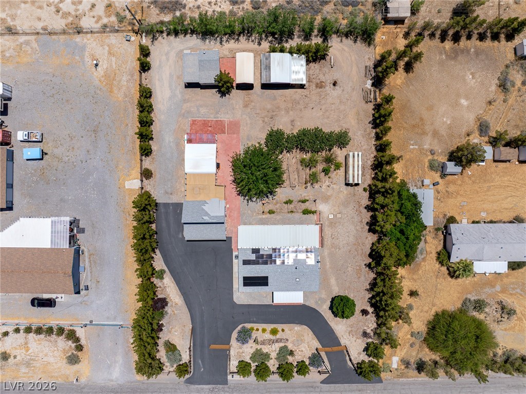 1831 West Horn Road Pahrump, NV 89048 - Photo 53 of 59 An aerial view highlights the expansive lot with multiple structures and a well-maintained driveway.