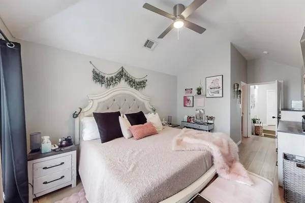 a bedroom with a bed and a chandelier