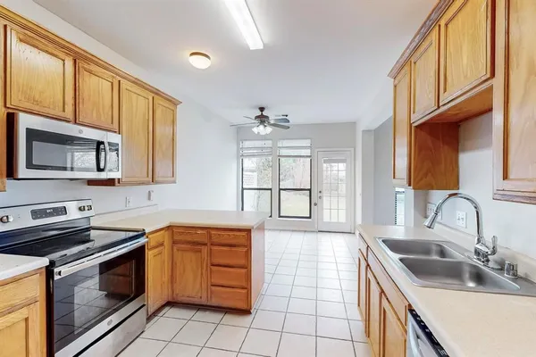 a kitchen that has a sink and a stove
