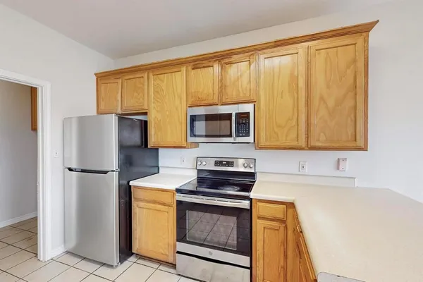 a kitchen with a refrigerator sink and microwave