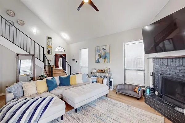 a living room with furniture a flat screen tv and a fireplace