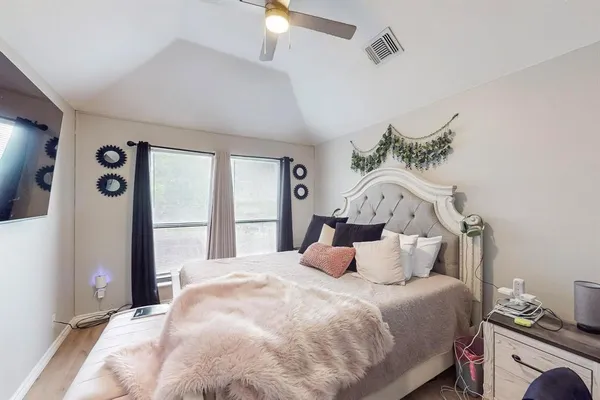 a bedroom with a bed and a window