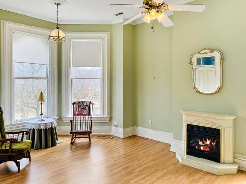 110 Akenside Road Riverside, IL 60546 - Photo 11 of 29 a living room with couches chair and a fireplace with wooden floor
