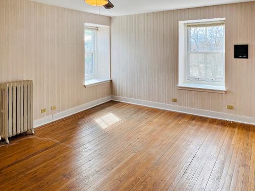 110 Akenside Road Riverside, IL 60546 - Photo 15 of 29 a view of an empty room with wooden floor and a window