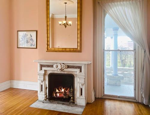 110 Akenside Road Riverside, IL 60546 - Photo 3 of 29 a view of a livingroom with a fireplace and window