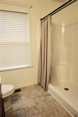 a bathroom with a shower and a toilet
