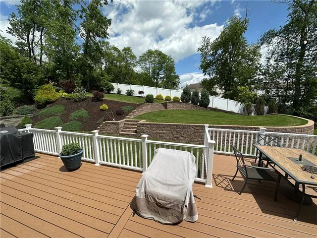 a view of a deck with chairs and wooden floor