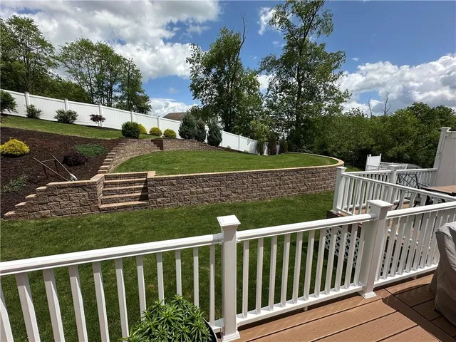 a view of a wooden deck and yard