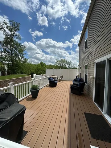 a view of balcony with wooden floor and seating space