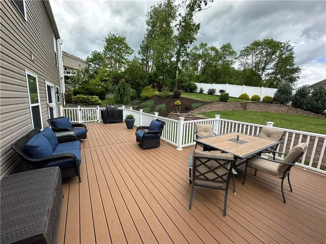 a view of a patio with table and chairs and couches
