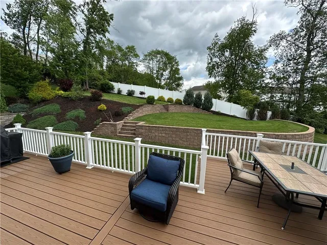 a view of a deck with furniture and wooden floor