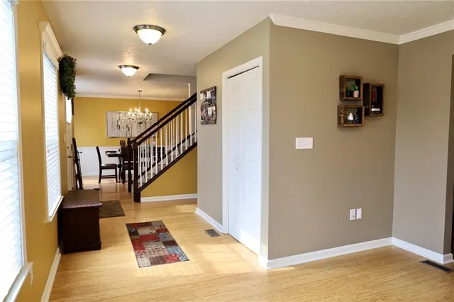 a view of entryway and hall with wooden floor
