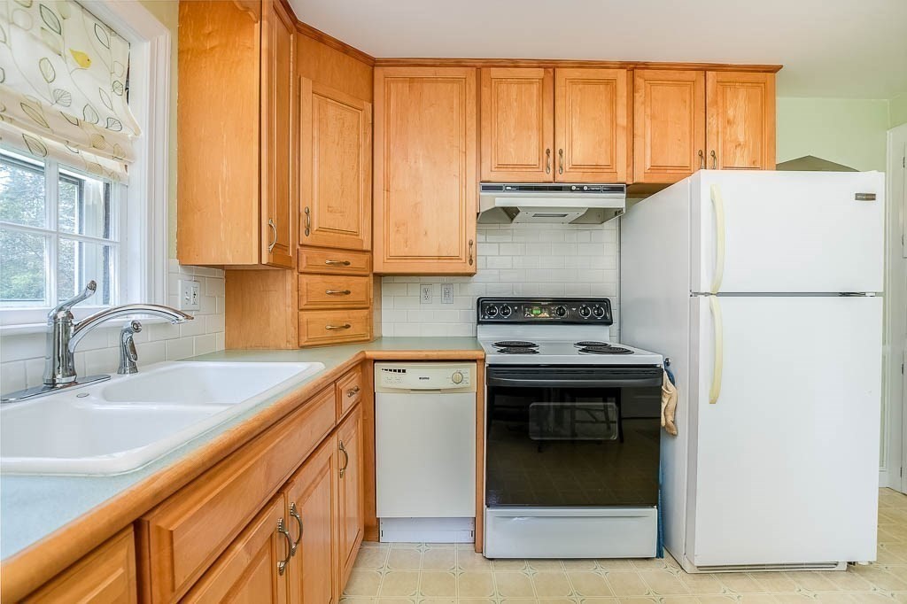 46 Park Street Dedham, MA 02026 - Photo 18 of 35 a kitchen with a sink stove and refrigerator