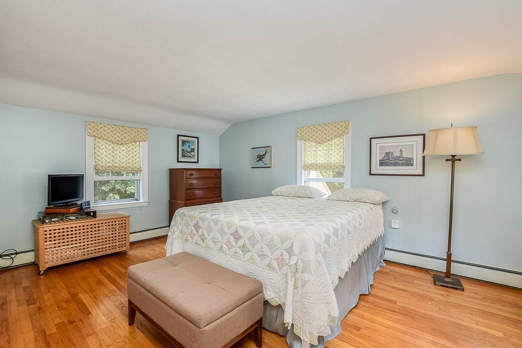 46 Park Street Dedham, MA 02026 - Photo 23 of 35 a bedroom with a bed and wooden floor