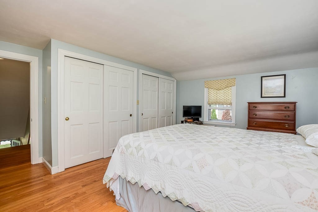 46 Park Street Dedham, MA 02026 - Photo 24 of 35 a spacious bedroom with a bed and a dresser