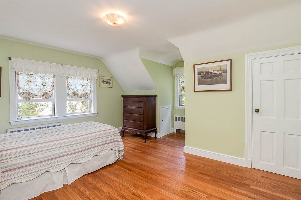 46 Park Street Dedham, MA 02026 - Photo 26 of 35 a bedroom with a bed and wooden floor