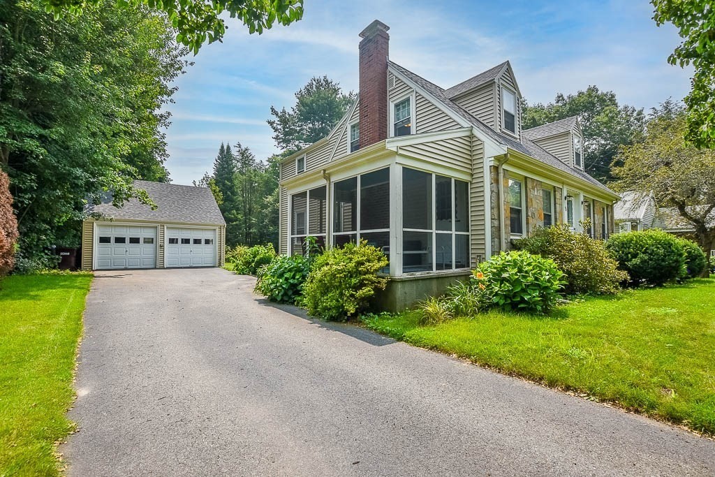 46 Park Street Dedham, MA 02026 - Photo 3 of 35 a front view of a house with a yard and garage