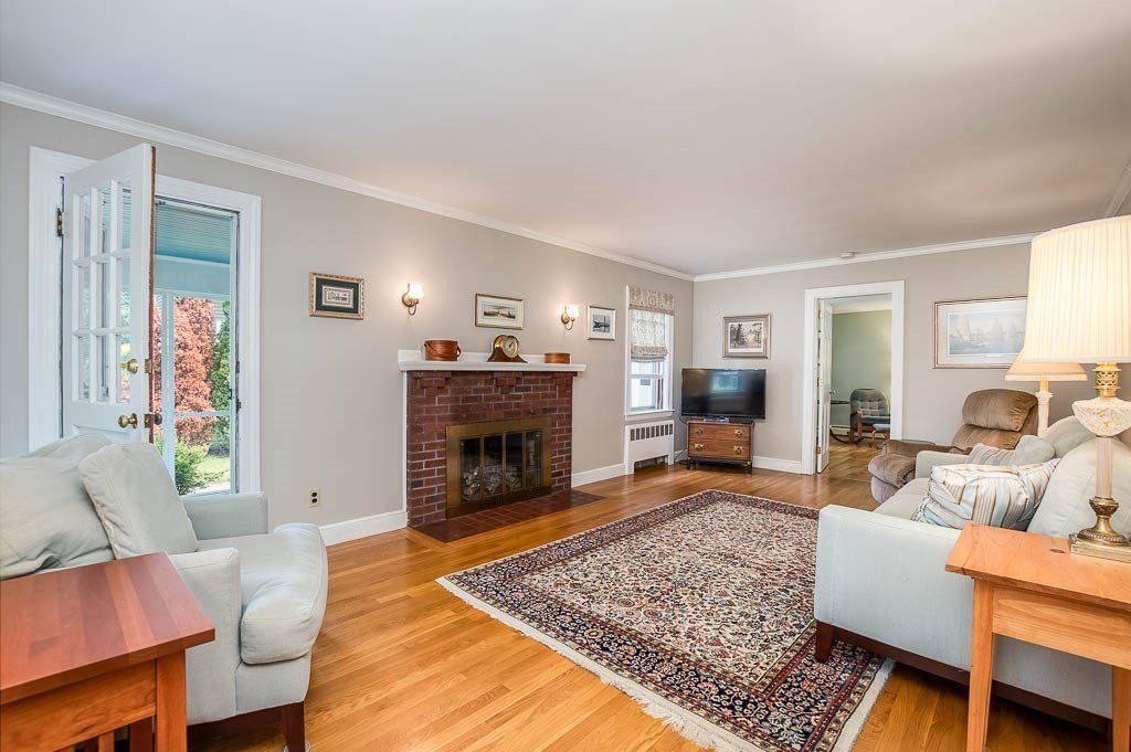 46 Park Street Dedham, MA 02026 - Photo 6 of 35 a living room with furniture and a fireplace