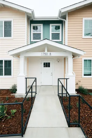 a front view of a house with wooden stairs