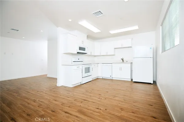 a view of kitchen with wooden floor