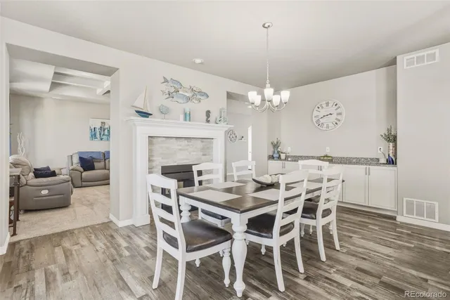 a view of a dining room with furniture wooden floor and chandelier