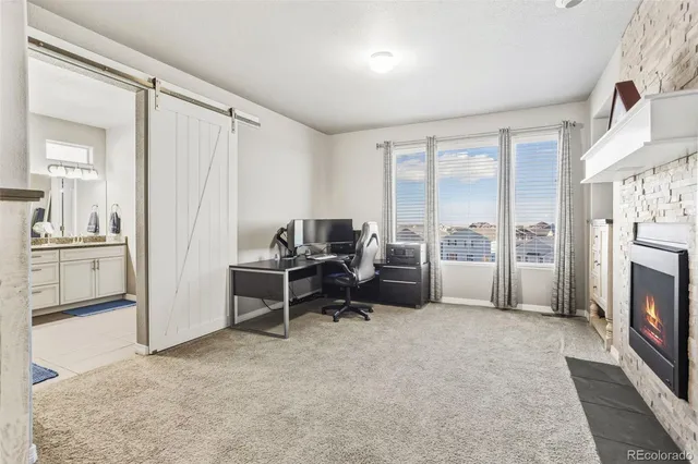 a view of a livingroom with furniture and a fireplace
