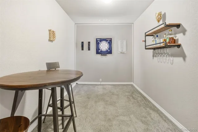 a view of a workspace with furniture and window