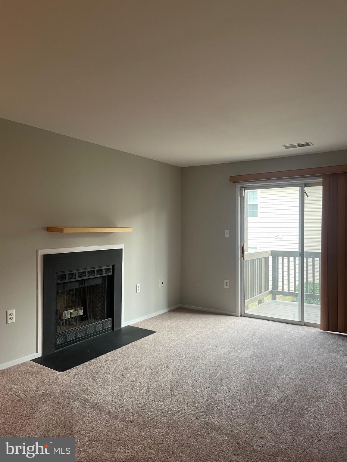 7828 Harrowgate Circle, Unit C Springfield, VA 22152 - Photo 11 of 11 a view of an empty room with a fireplace