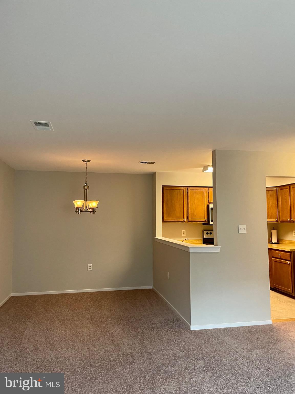 7828 Harrowgate Circle, Unit C Springfield, VA 22152 - Photo 2 of 11 an empty room with windows