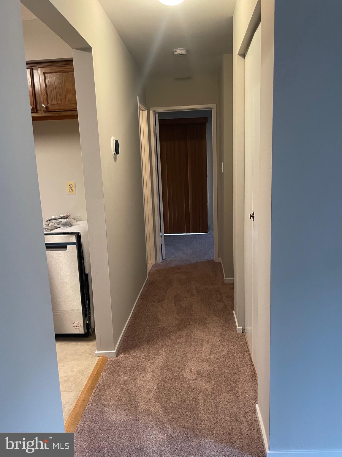 7828 Harrowgate Circle, Unit C Springfield, VA 22152 - Photo 5 of 11 a view of a hallway with wooden floor and closet