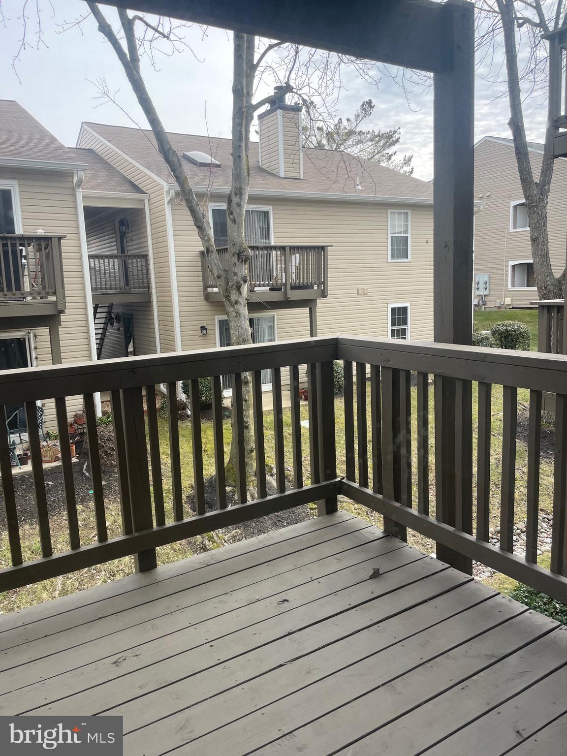 7828 Harrowgate Circle, Unit C Springfield, VA 22152 - Photo 10 of 11 a balcony view with wooden floor and fence