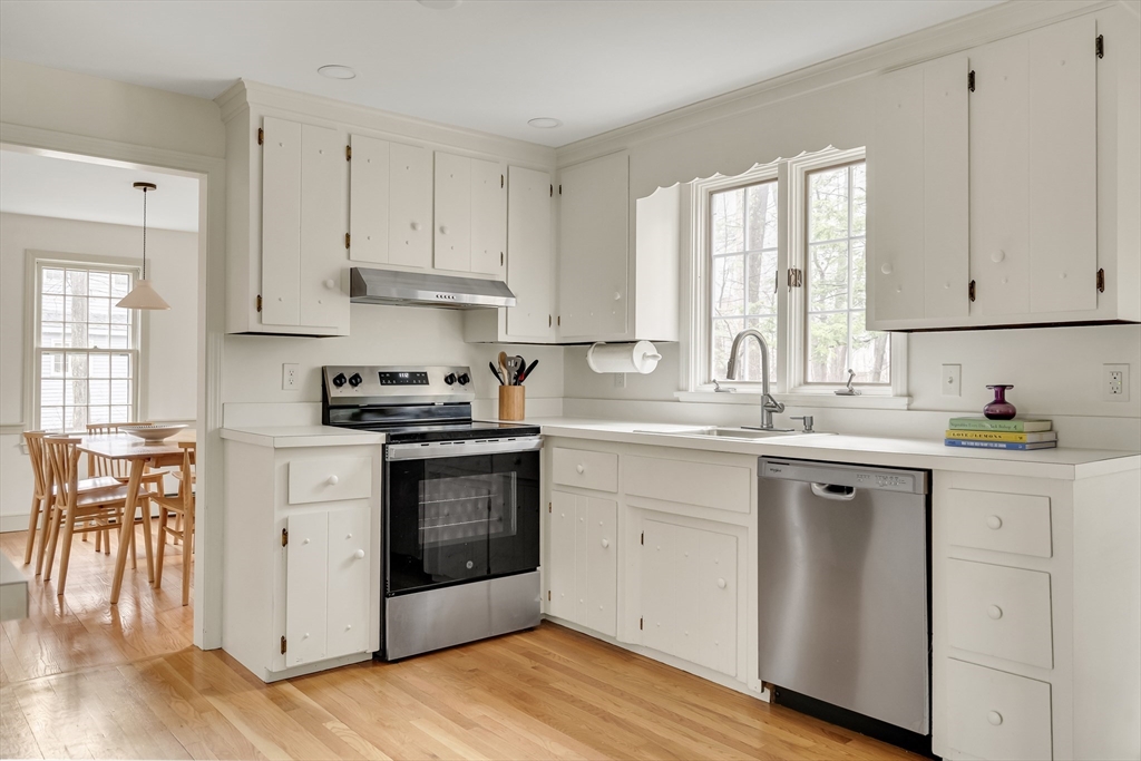 8 Highland Road Acton, MA 01720 - Photo 15 of 36 a kitchen with granite countertop white cabinets and white appliances